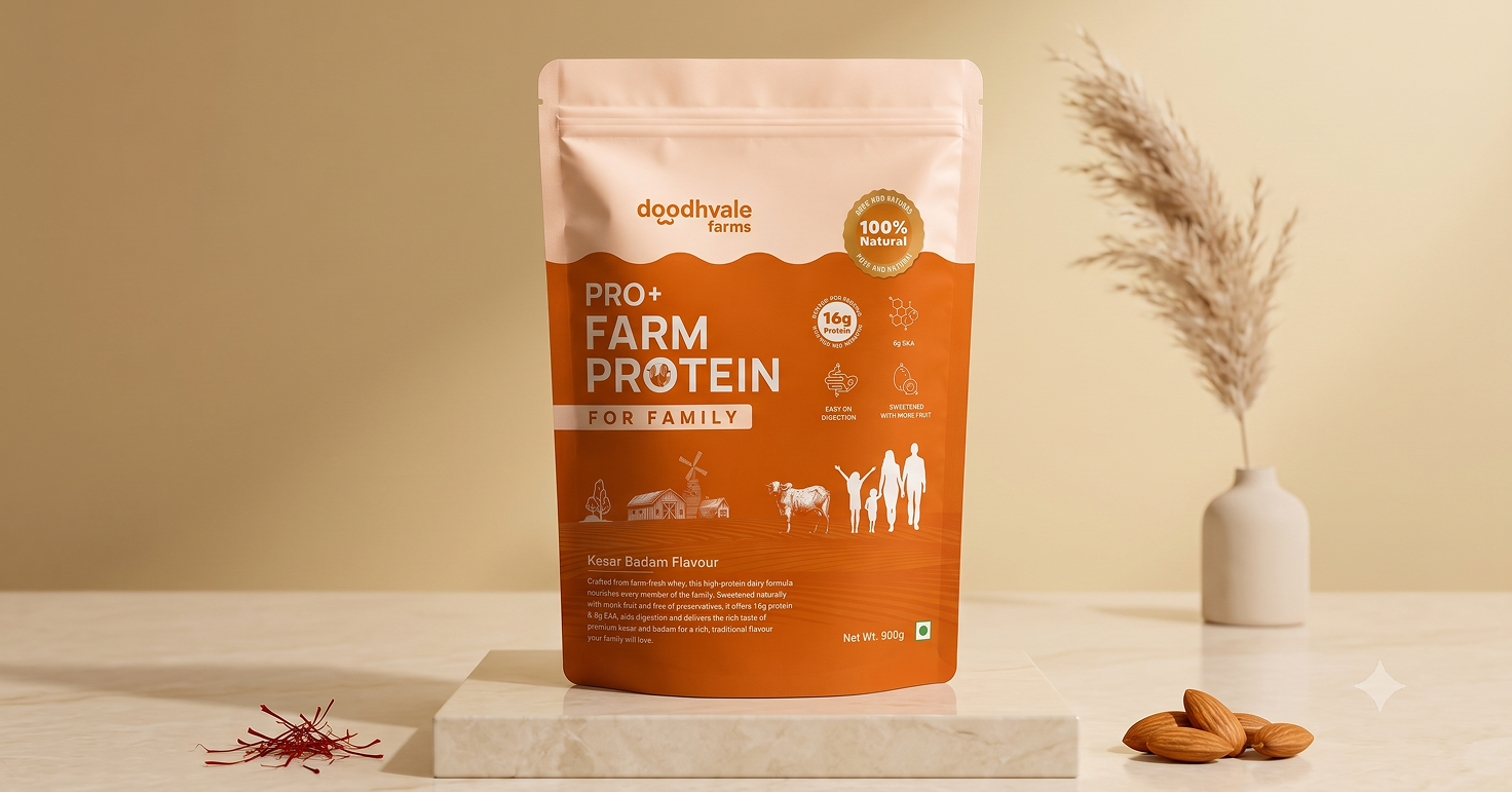 Doodhvale Farms Pro+ Farm Protein for Family packaging displayed on a pedestal, featuring a warm orange and cream design with farm illustrations, protein benefits, and kesar badam flavour.